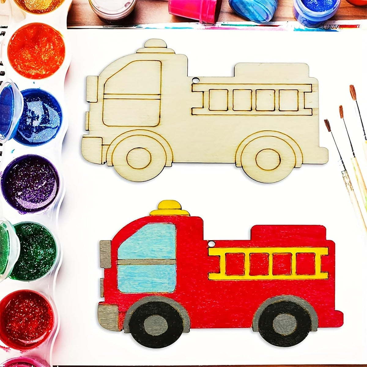 Wooden fire truck model with paint supplies on a white background