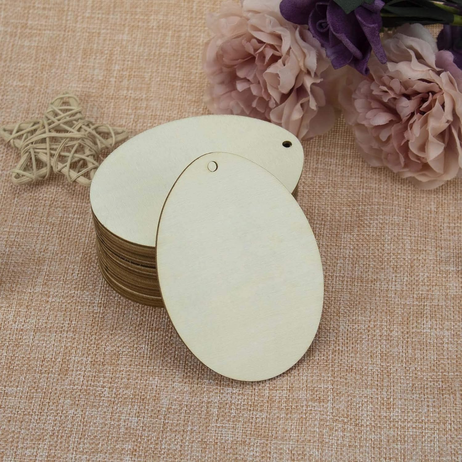 Round wooden tags on a textured fabric background with flowers and decorative elements.