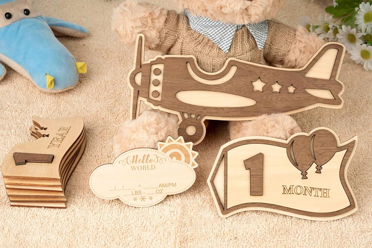 Wooden baby milestone cards with airplane design and teddy bear in the background