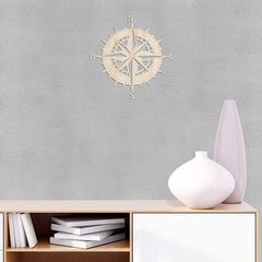 Wooden compass wall decoration on a gray wall with a shelf and vases below.