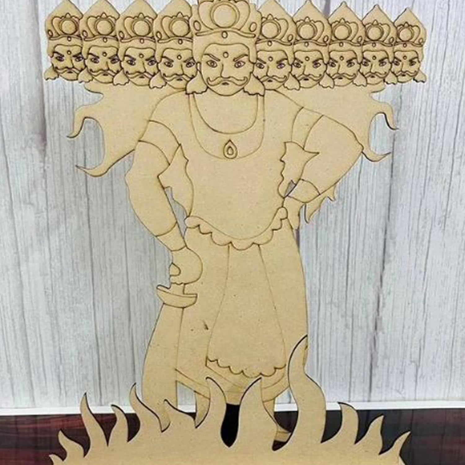 Wooden cutout of a deity with multiple faces on a wooden background
