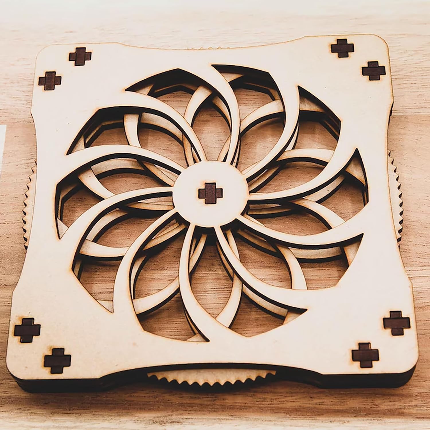 Wooden cooling pad with geometric design on a wooden surface