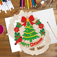 Christmas-themed wooden cutout with decorations on a wooden table with art supplies.