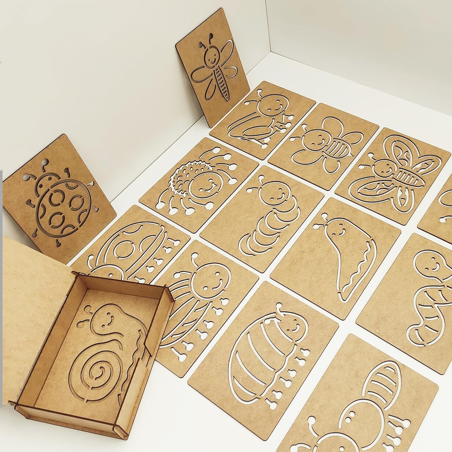 Cardboard cutouts of animals with a box on a white background