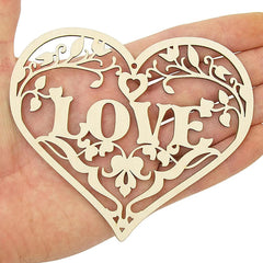 Heart-shaped decorative item with 'LOVE' cutout held in a hand