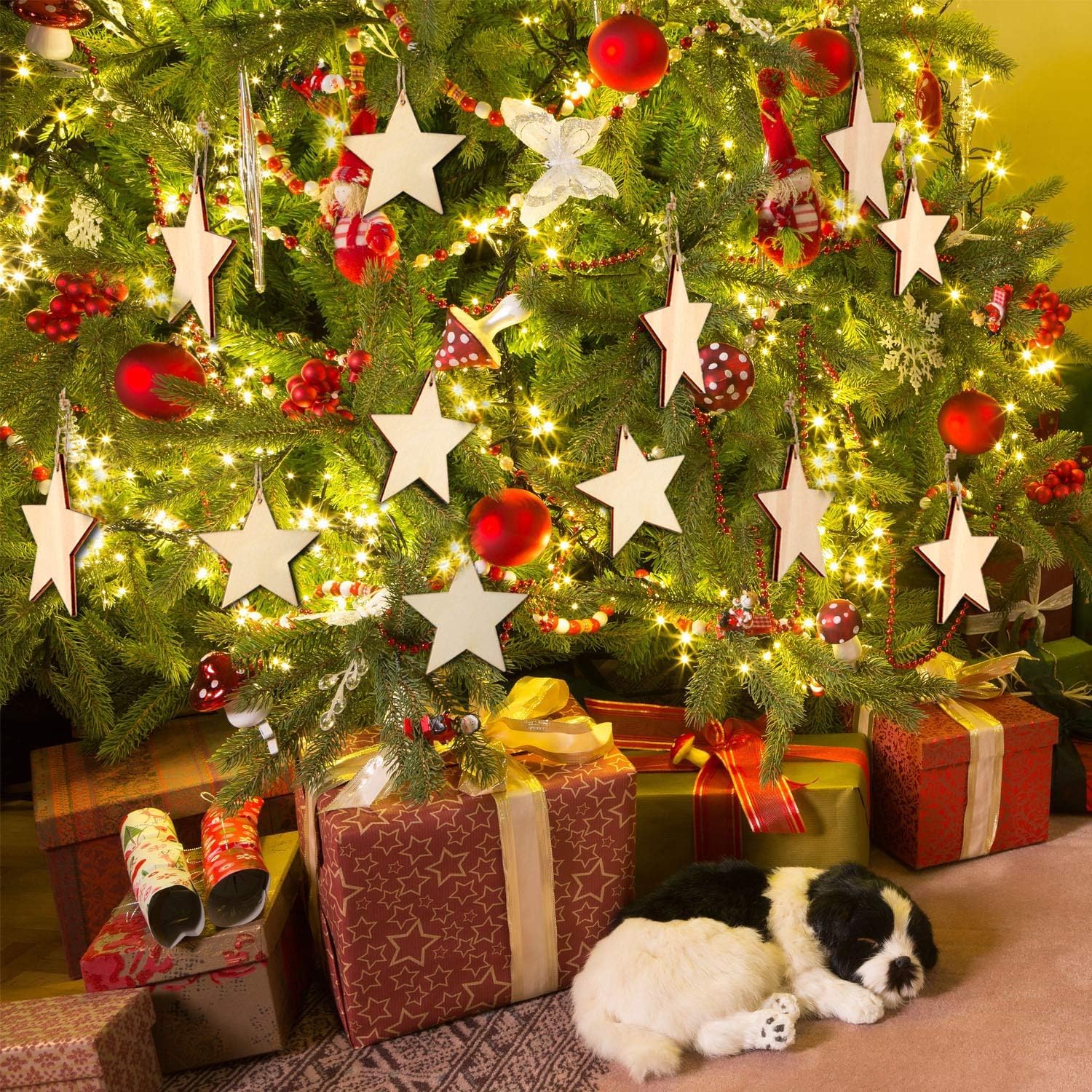 Decorated Christmas tree with ornaments, lights, and presents, with a dog lying on the floor.