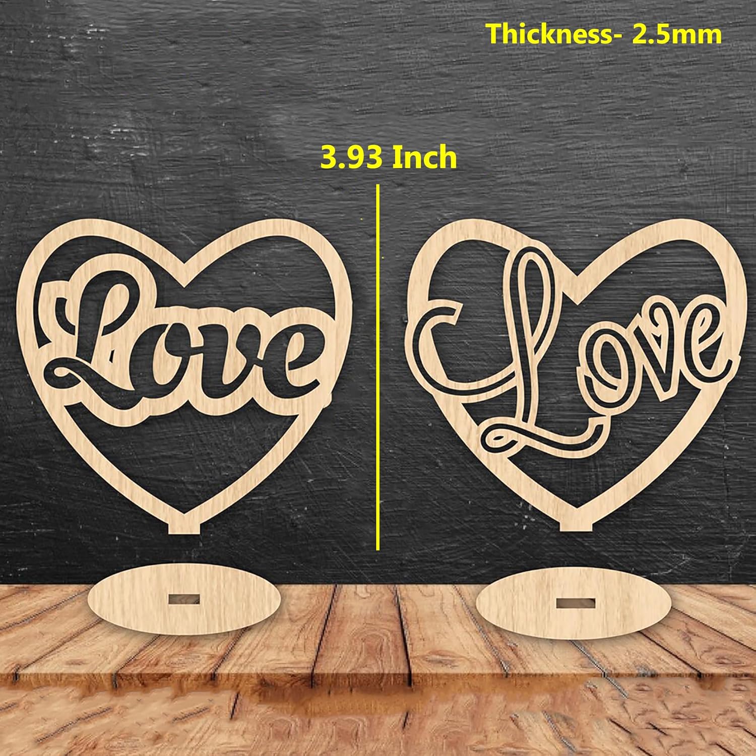 Two heart-shaped 'Love' signs with measurements on a wooden surface and dark background.