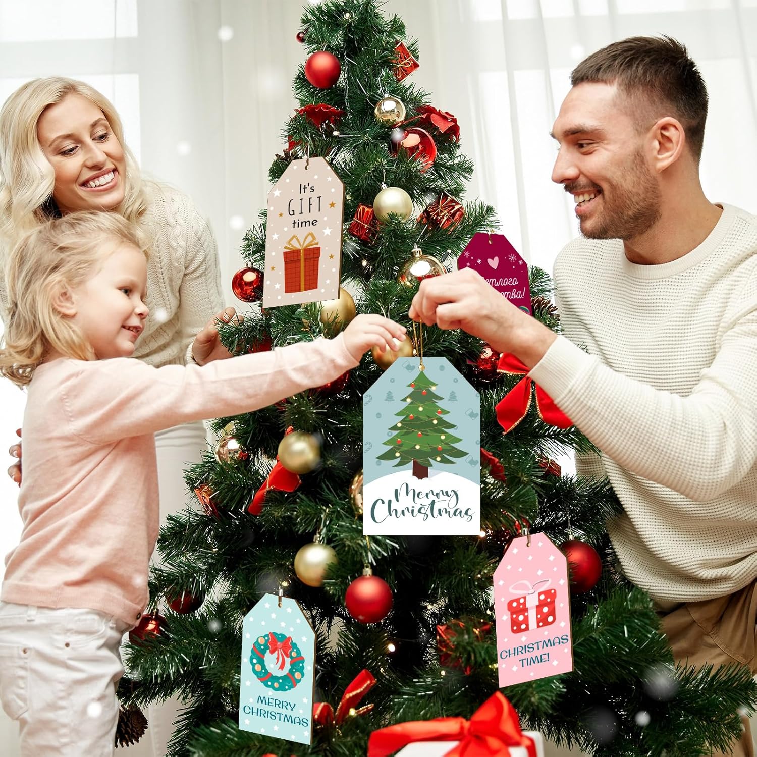 Family decorating a Christmas tree with decorative gift tags
