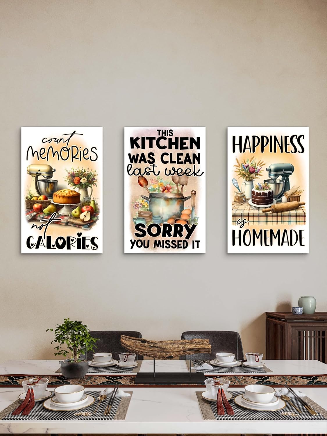 Three kitchen-themed wall posters on a wall above a dining table.