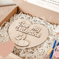 Heart-shaped wooden plaque with 'Bee my Valentine' text in a box