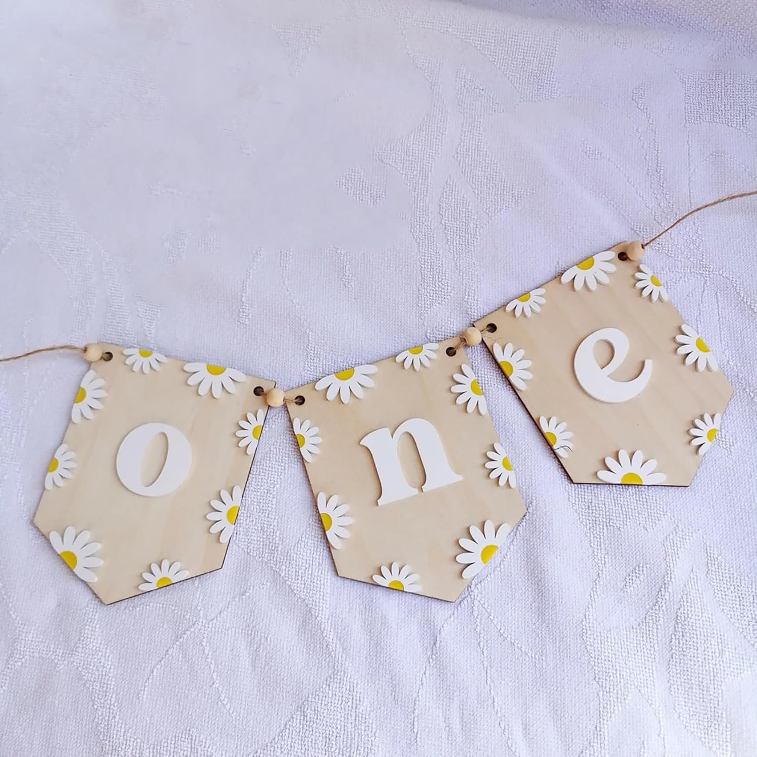 Decorative banner with 'One' and daisy flowers on a light background