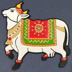 Decorative cow figure with colorful patterns on a dark background