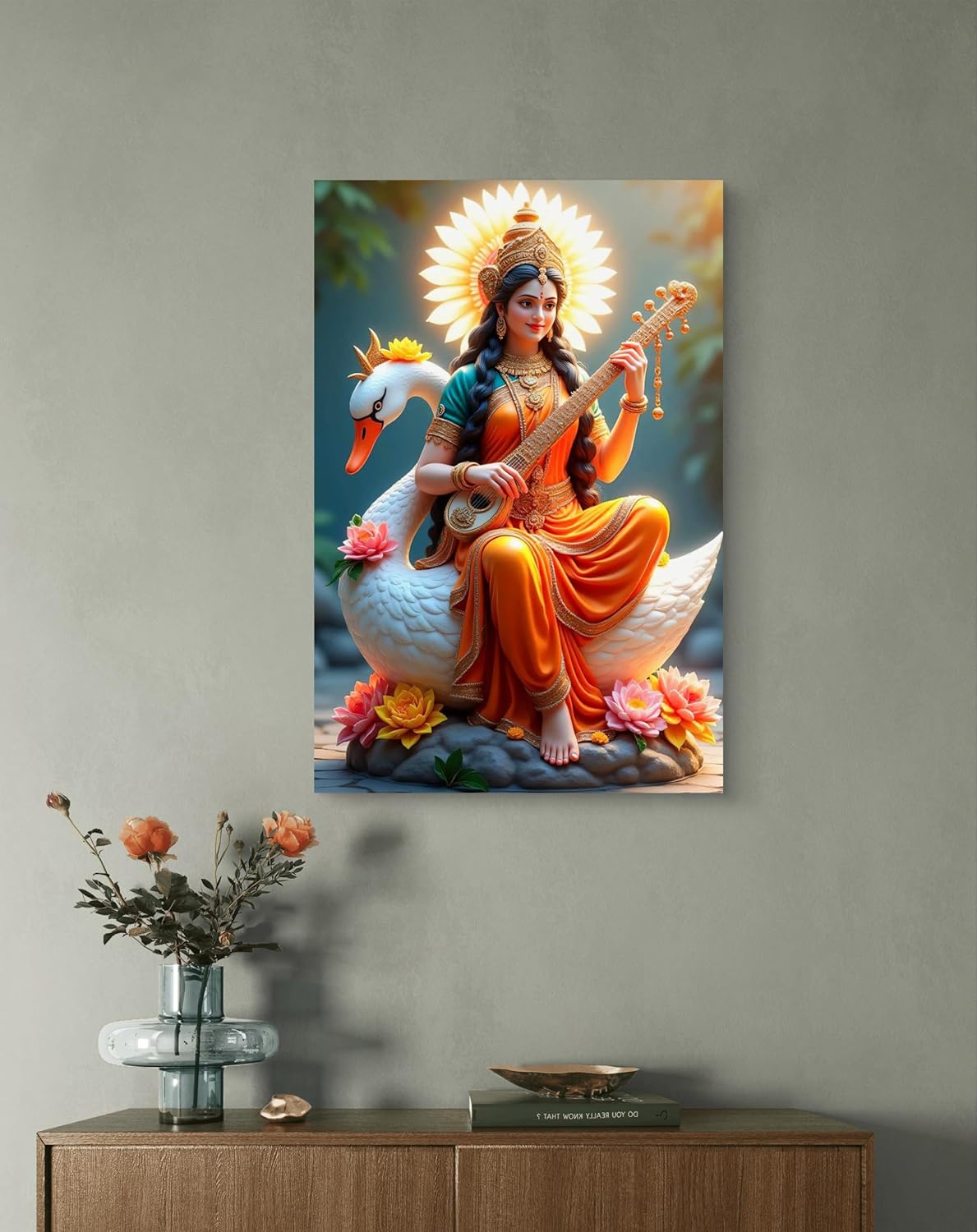 Decorative wall art of a goddess playing a stringed instrument on a swan, displayed on a gray wall above a wooden cabinet.