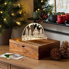 Wooden Christmas decoration with 'Merry Christmas' sign on a table with festive background.
