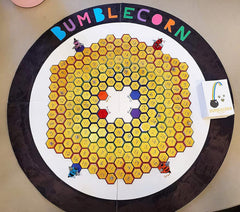 Round board game with hexagonal grid and colorful characters, branded 'Bumblecorn'.