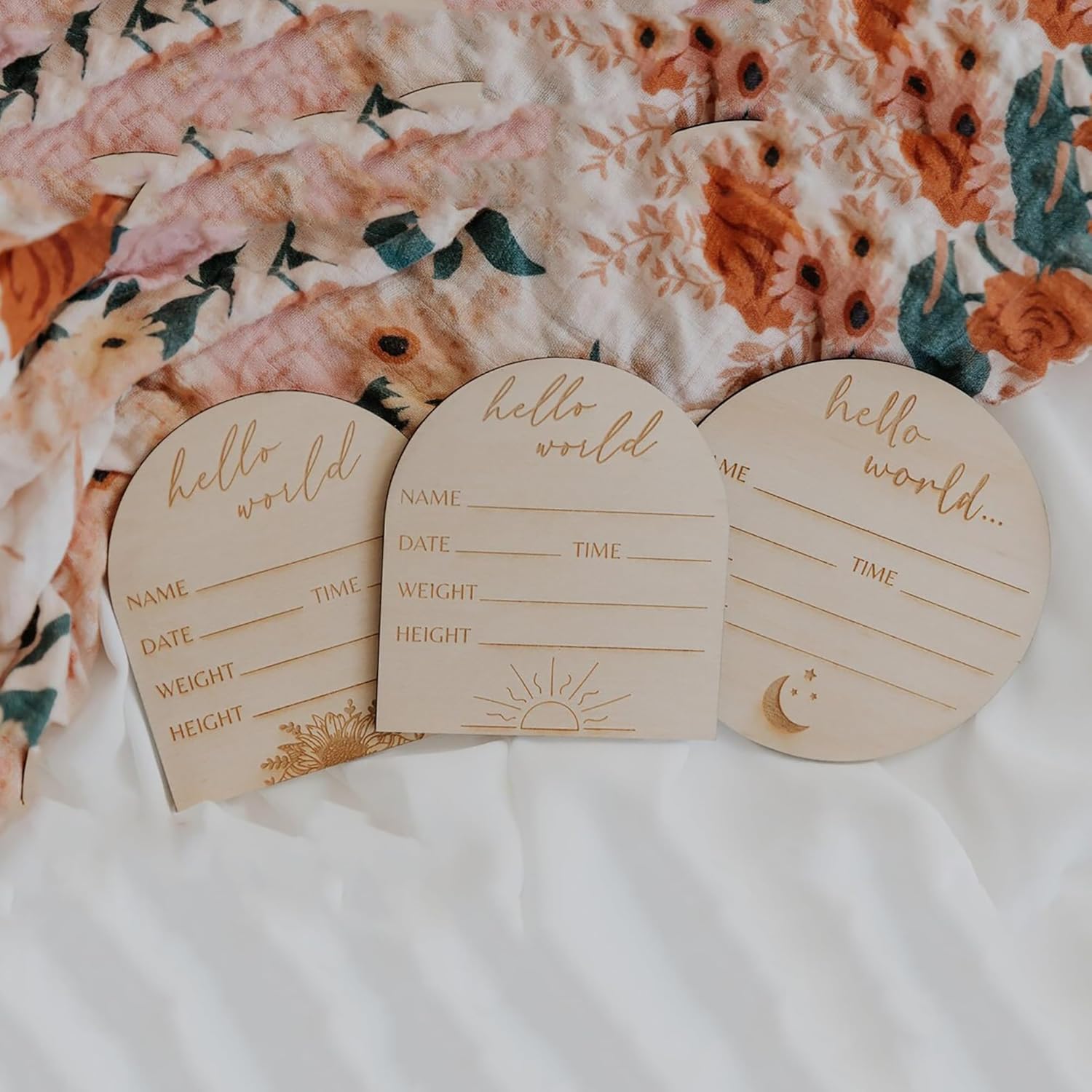Three wooden baby登记 cards with 'hello world' text on a floral background