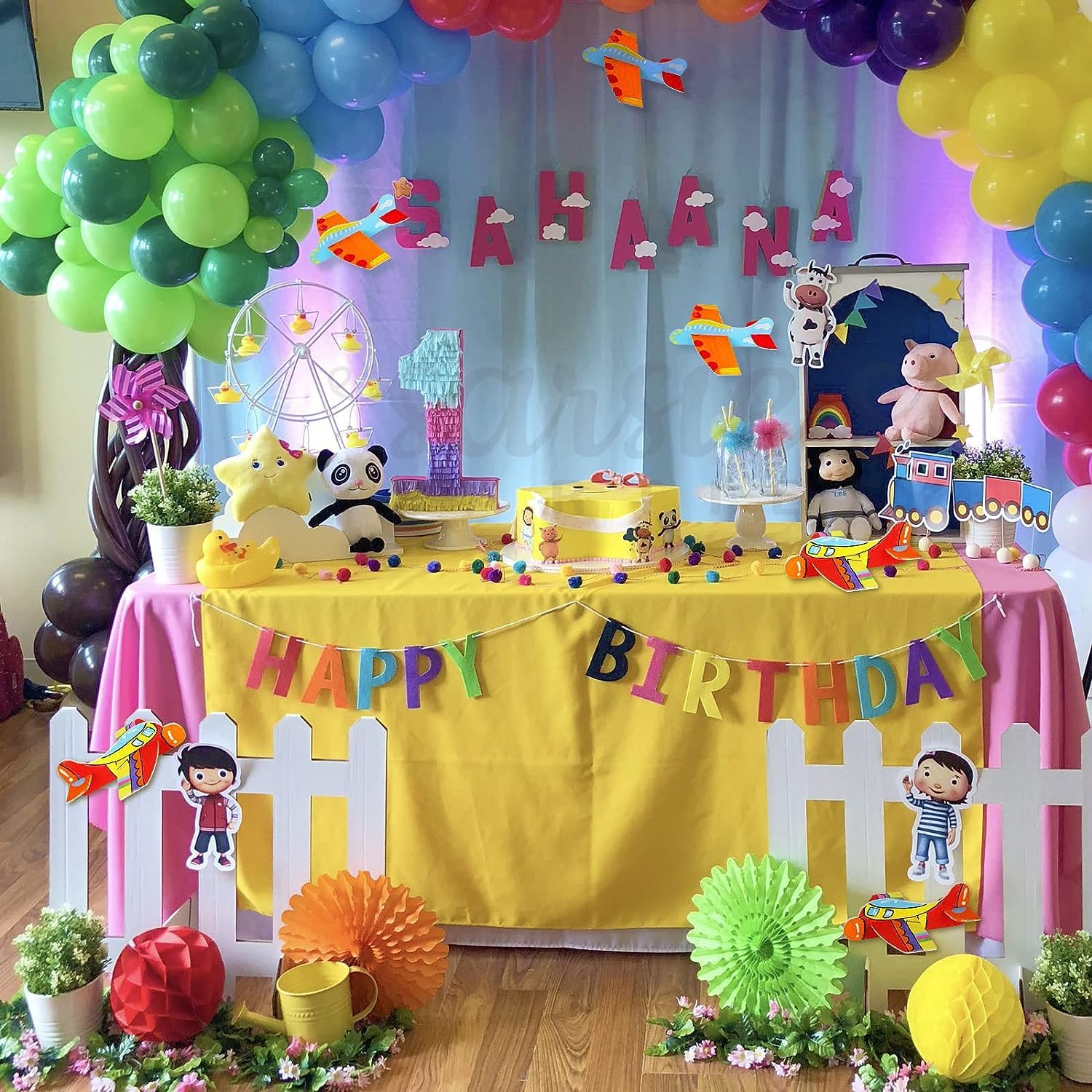 Birthday party setup with colorful balloons, decorations, and a 'Happy Birthday' banner.