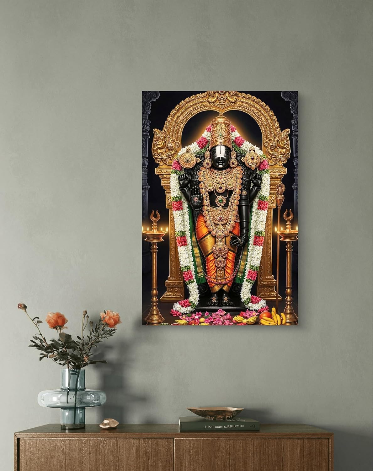 Decorative wall art of a神像 on a gray wall with a wooden cabinet below.