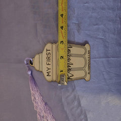 Measurement of a decorative item with 'My First' and 'Alhamdulillah' text on a purple fabric background.