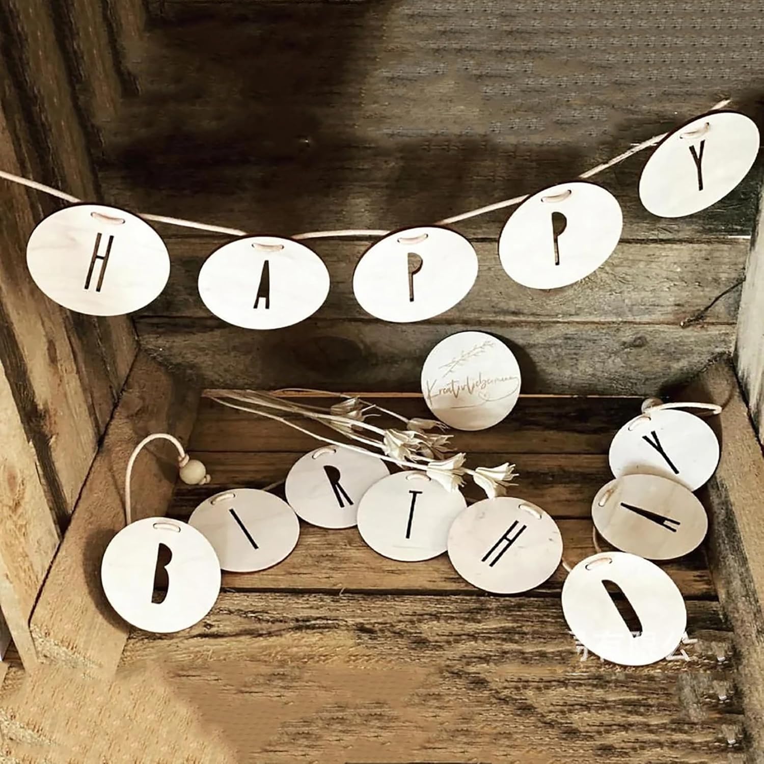 Decorative banner with 'Happy Birthday' on a wooden surface