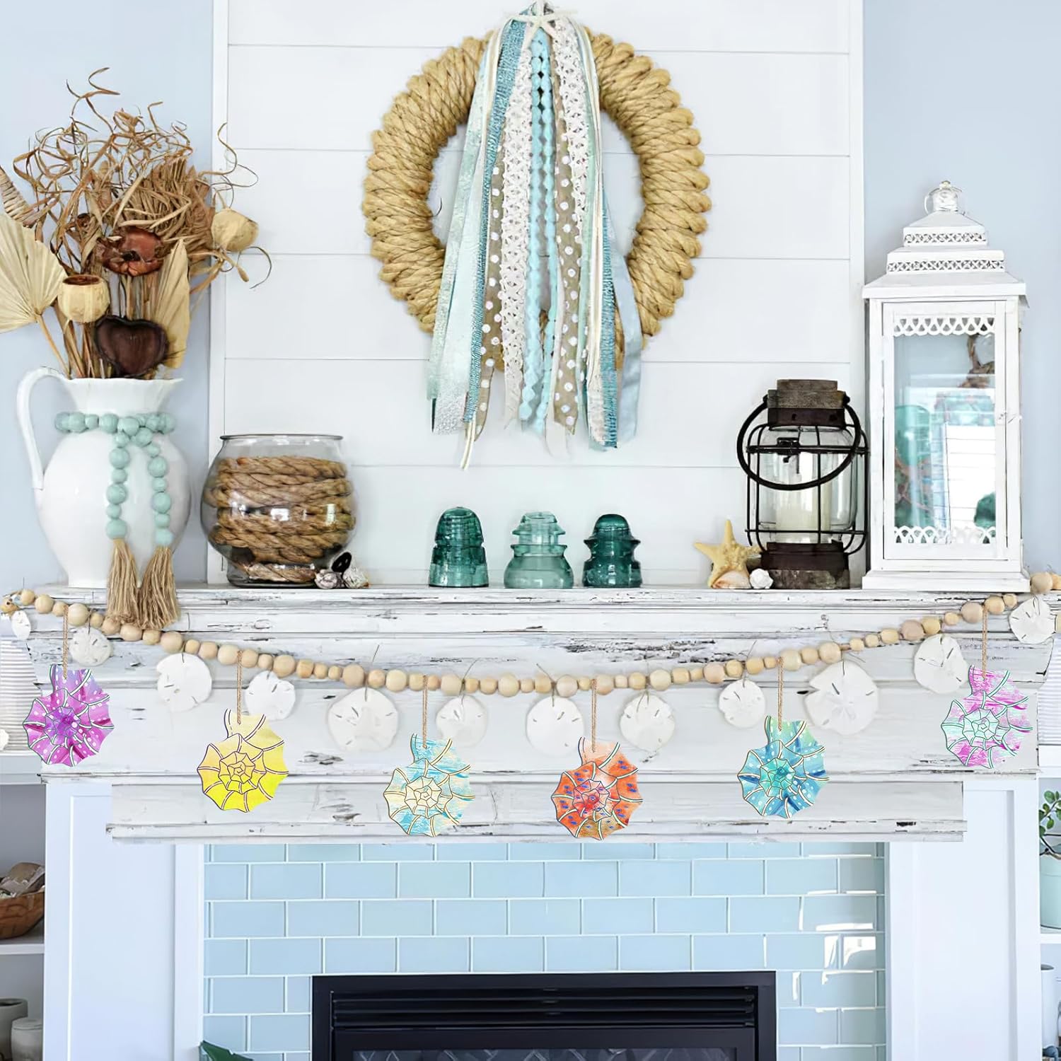 Decorative mantel with wreath, lanterns, and colorful decorations against a light blue wall.
