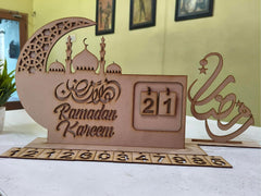 Wooden Ramadan Kareem calendar with decorative elements on a table.