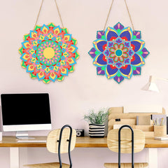 Two colorful mandala wall decorations hanging above a desk.
