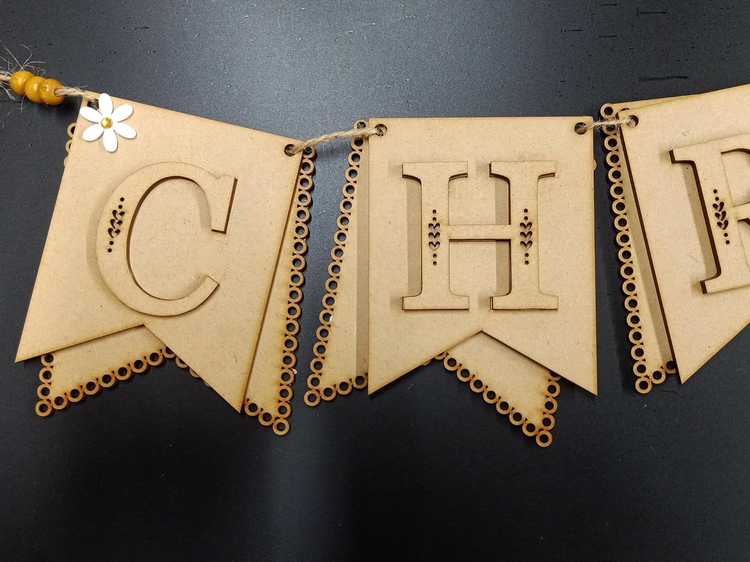 Wooden banner with cut-out letters on a dark background