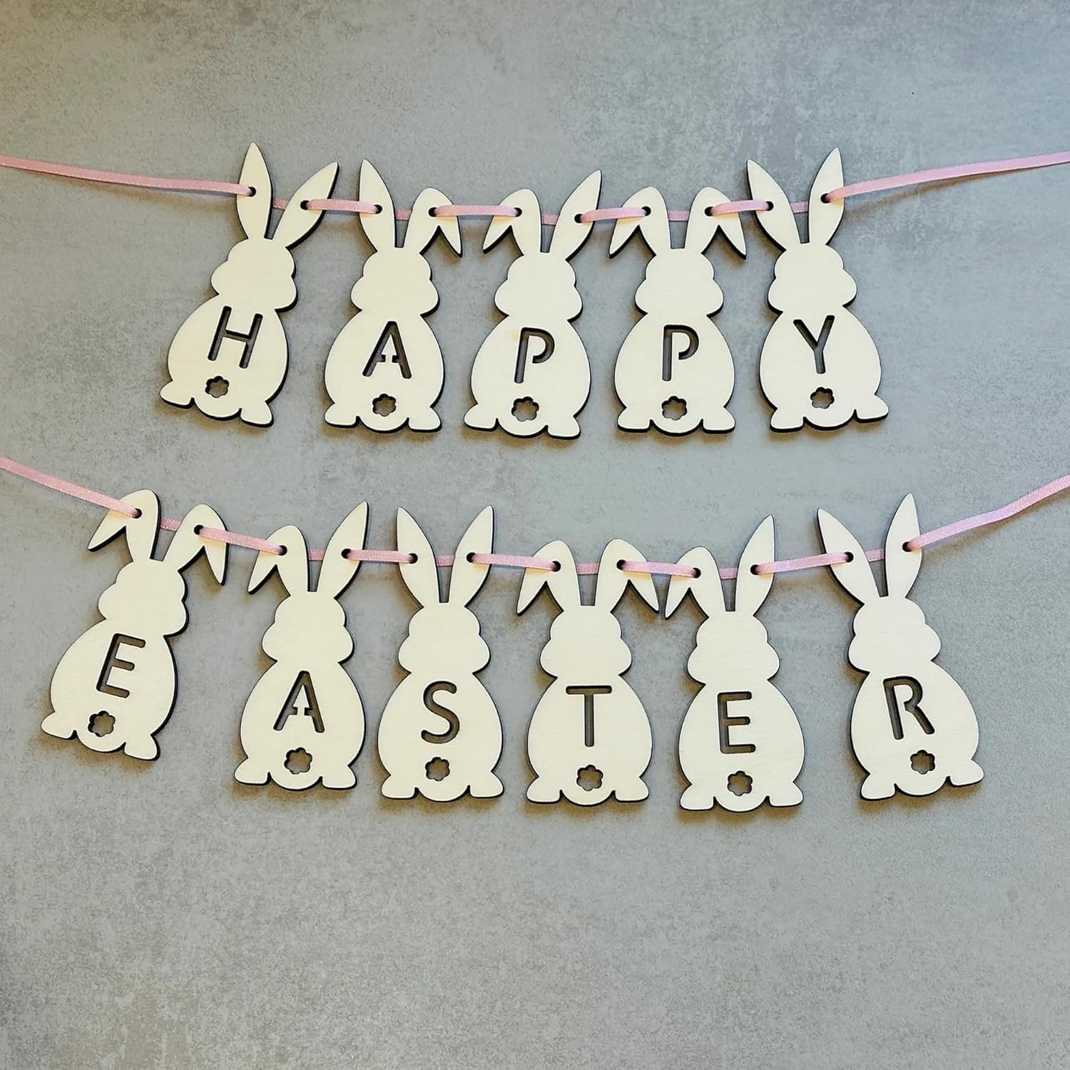 Happy Easter banner with bunny shapes on a gray background