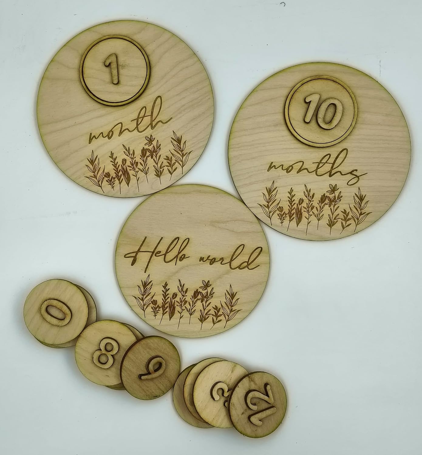 Set of wooden discs with engraved numbers and phrases on a white background