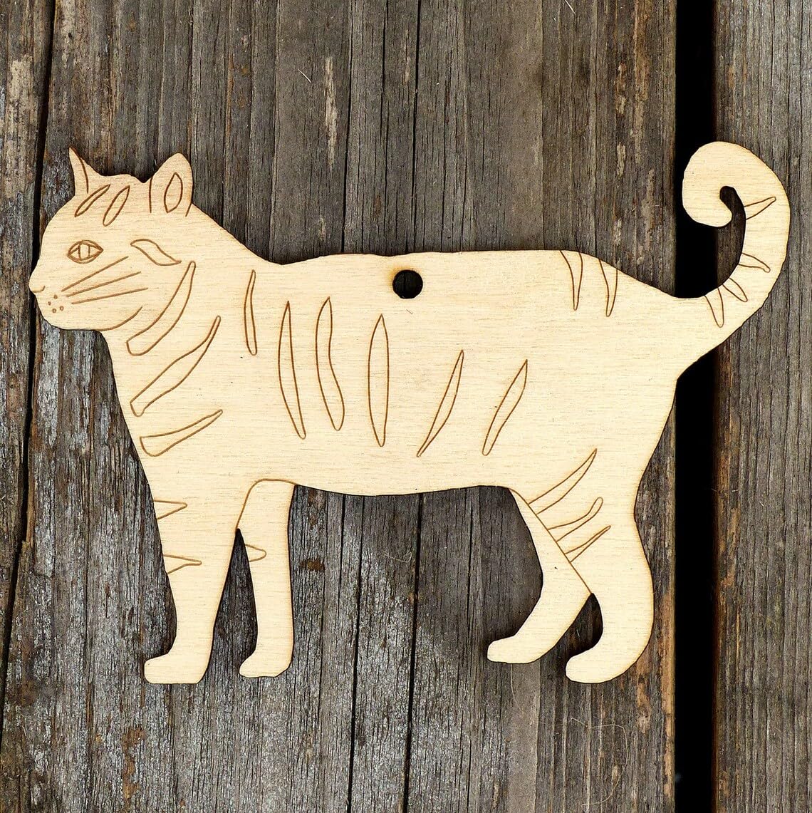 Wooden cat-shaped ornament on a wooden surface