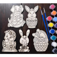 Easter-themed coloring pages with paintbrushes and paint on a wooden surface