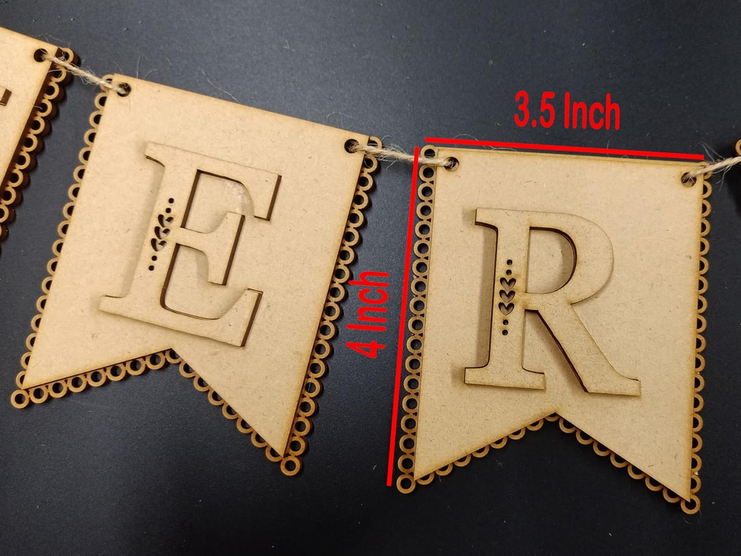 Decorative banner with 'E' and 'R' letters and measurements on a dark background