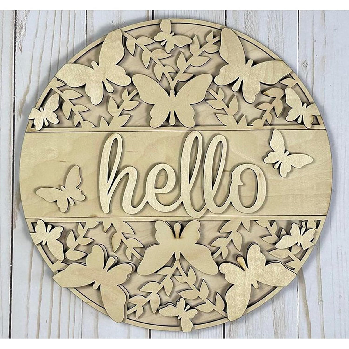 Decorative wall art with butterflies and the word 'hello' on a wooden background