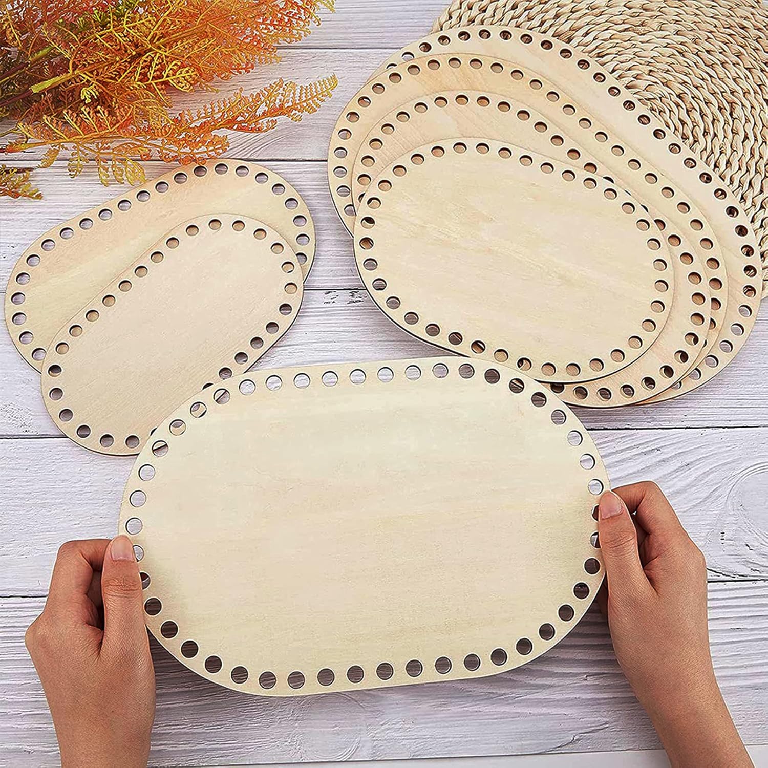 Wooden circular cutouts with holes on a wooden surface