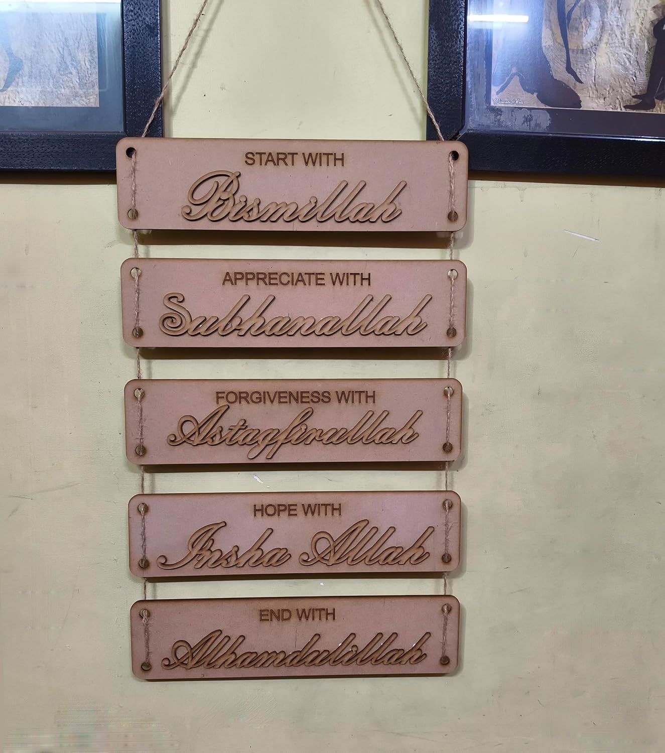 Decorative wall hanging with engraved phrases on a light background