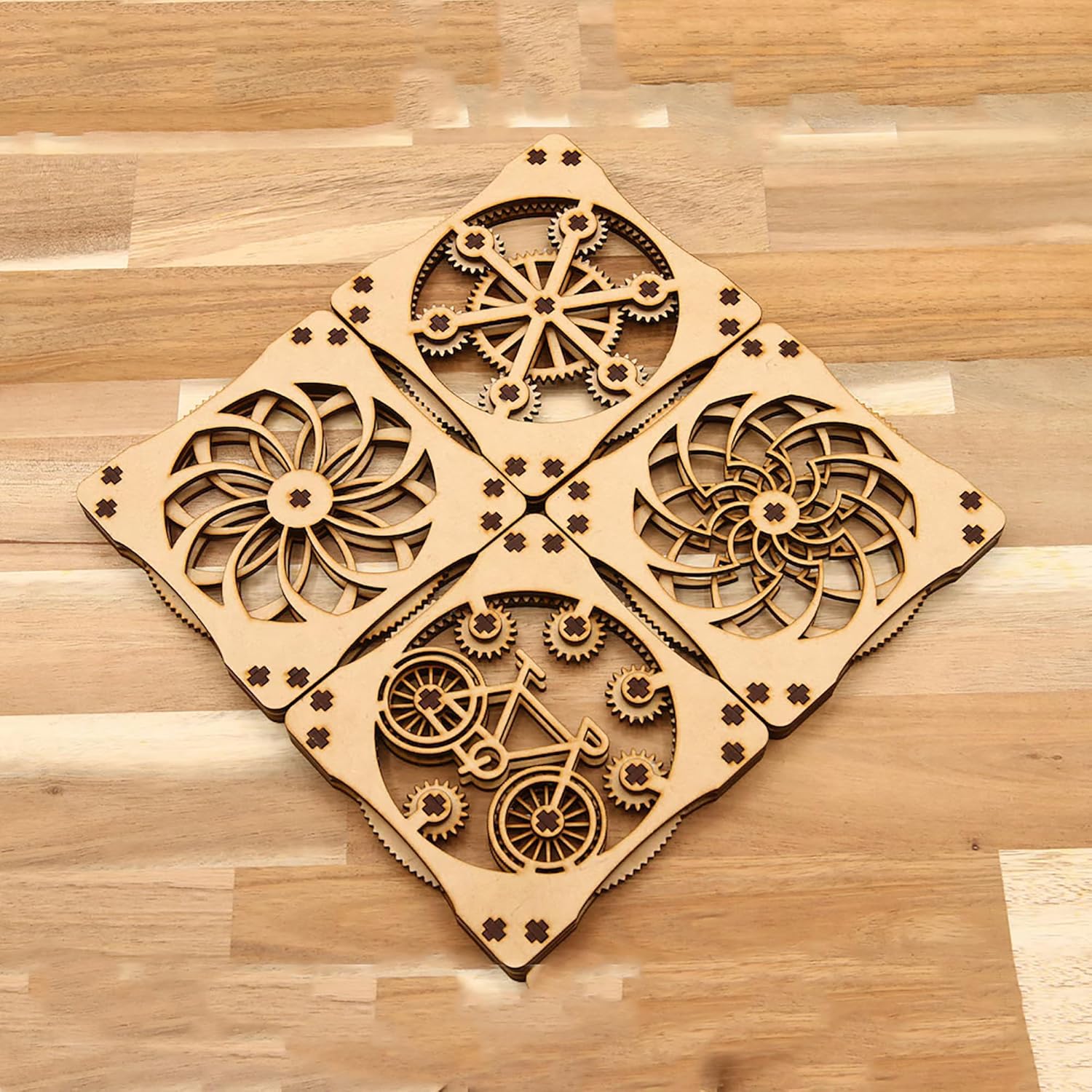 Four wooden coasters with mechanical design on a wooden surface