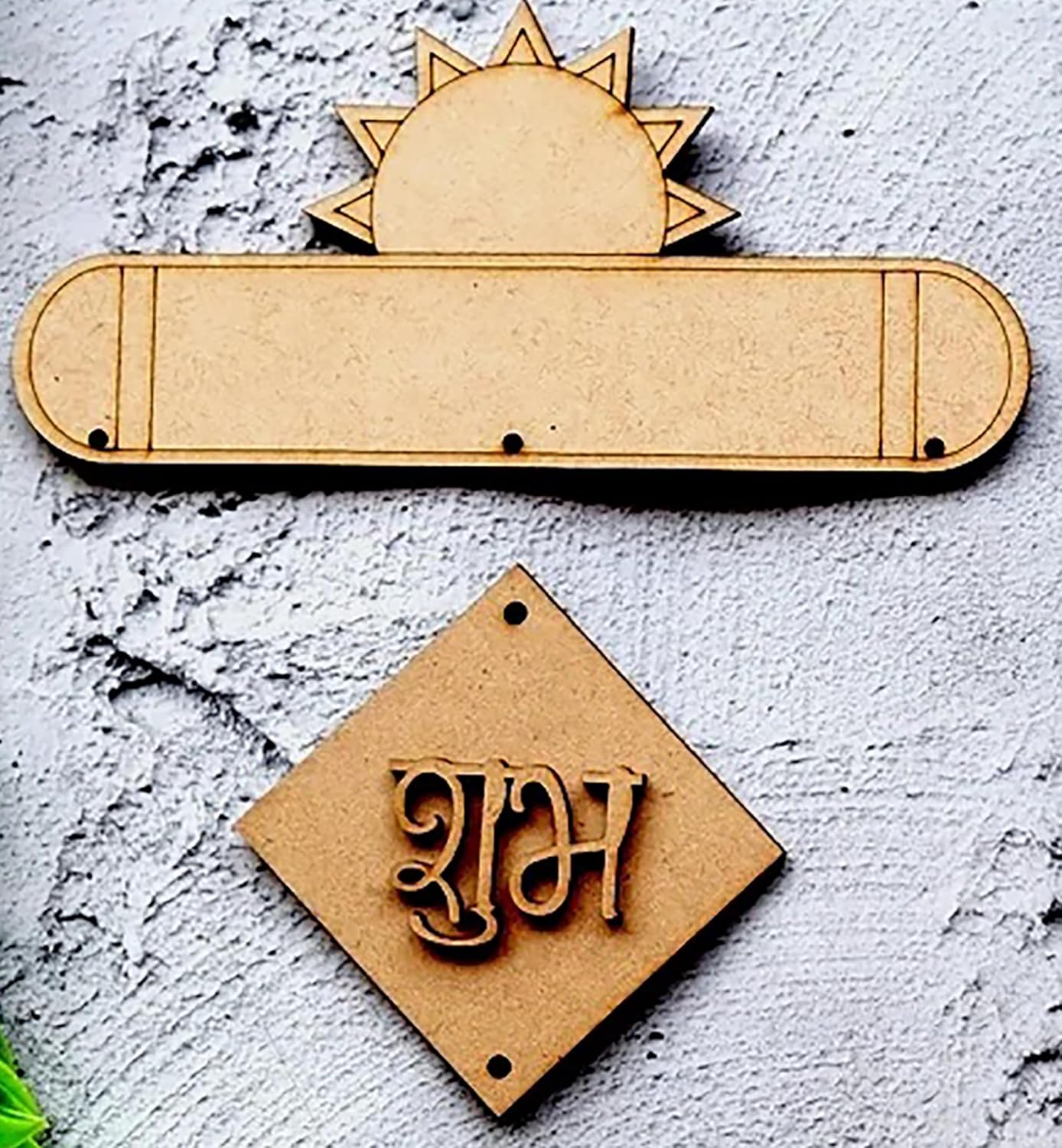 Wooden decorative items with sun design and engraved text on a textured surface