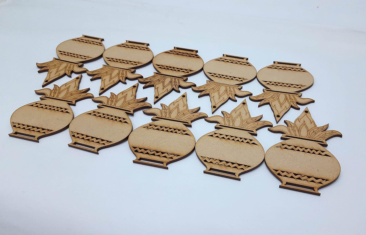 Set of wooden pineapple-shaped ornaments on a white background