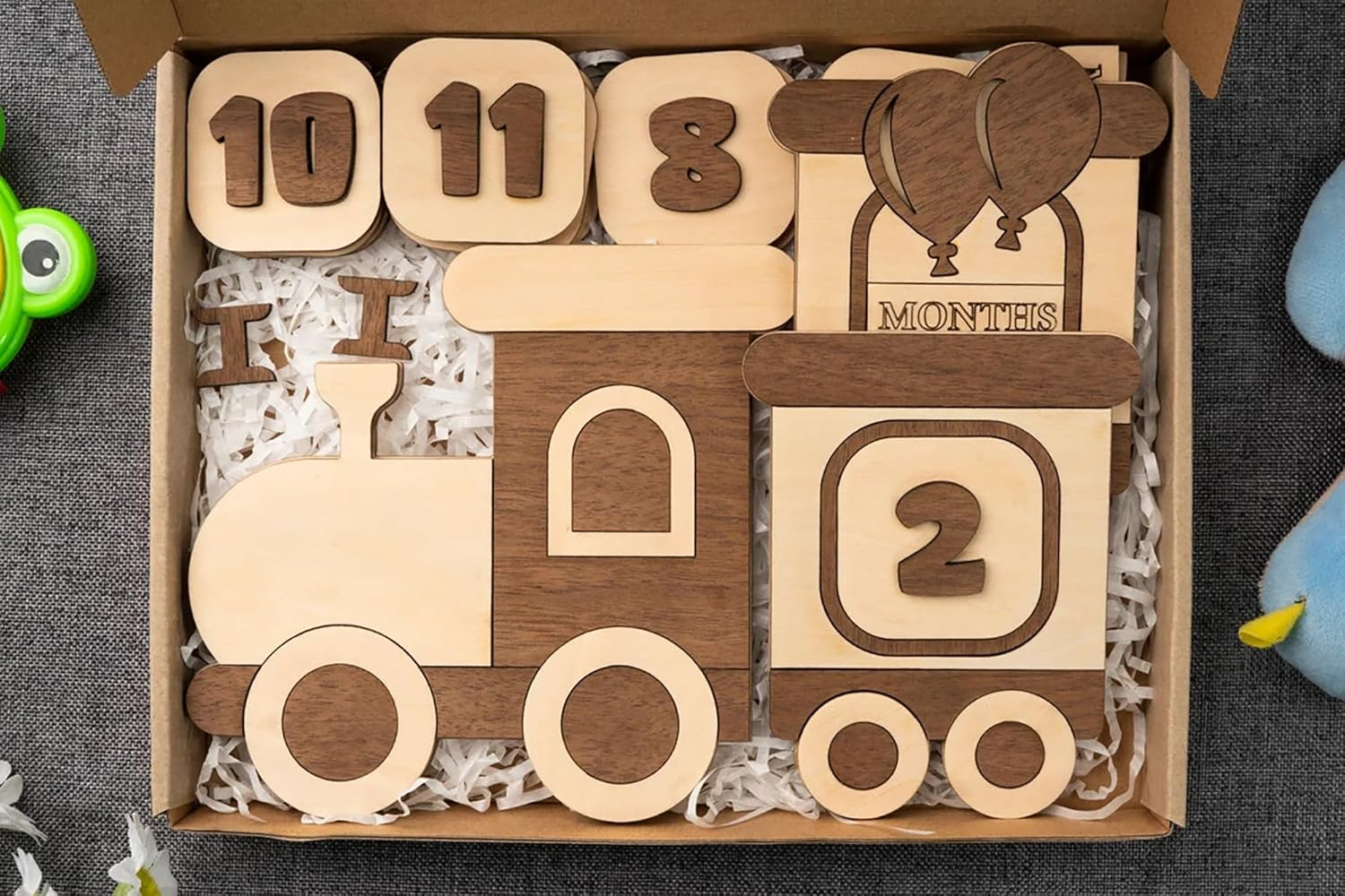 Wooden baby milestone blocks with numbers and letters in a box