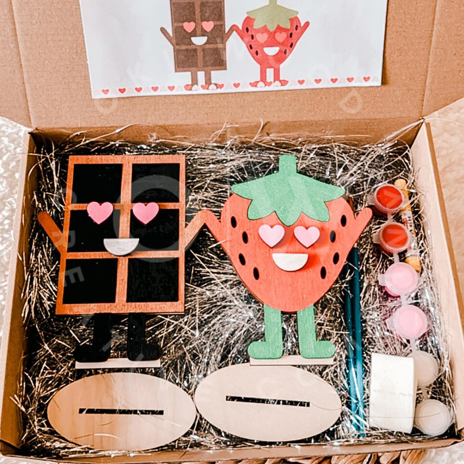 Wooden craft kit with strawberry character and supplies in a box