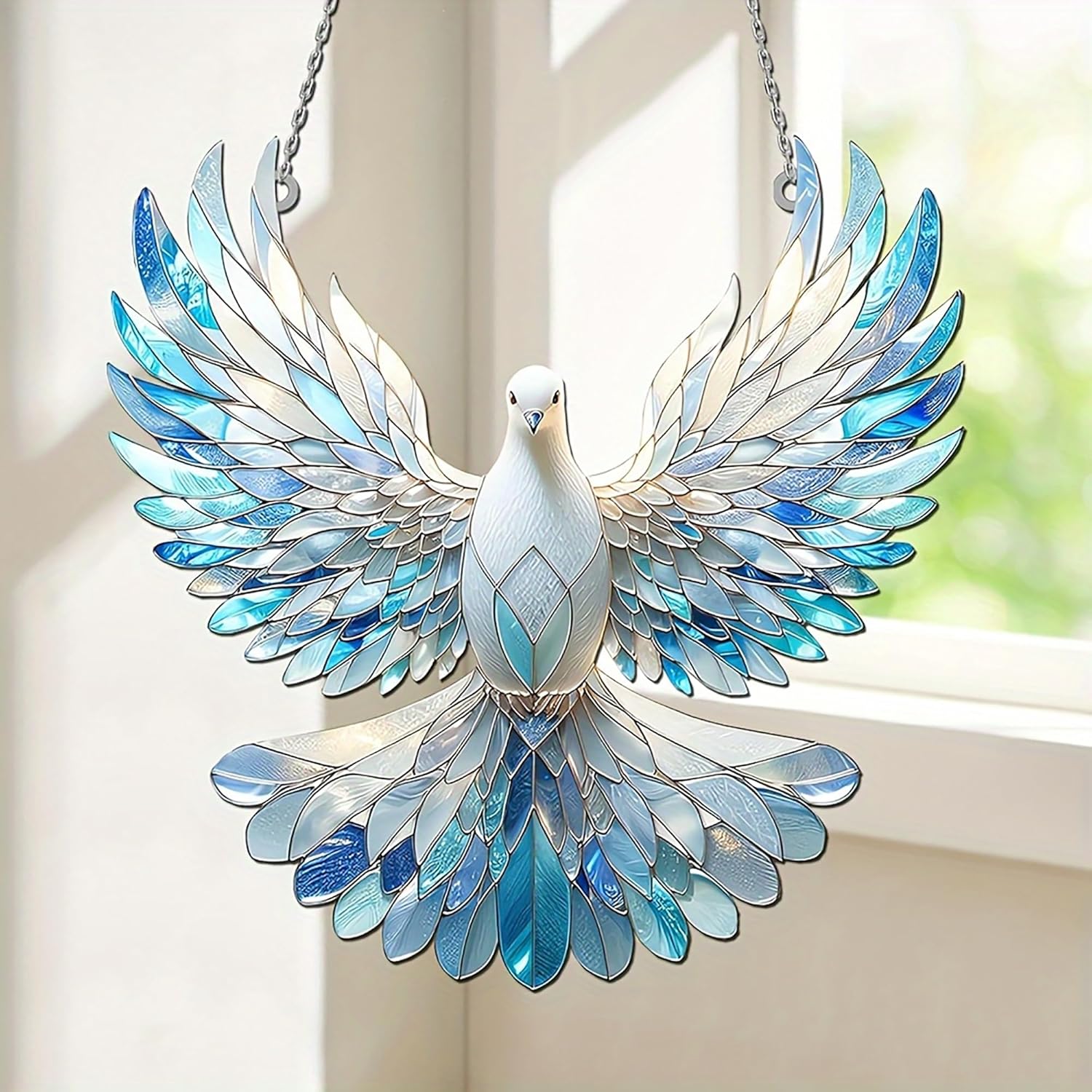 Decorative stained glass dove hanging by a window