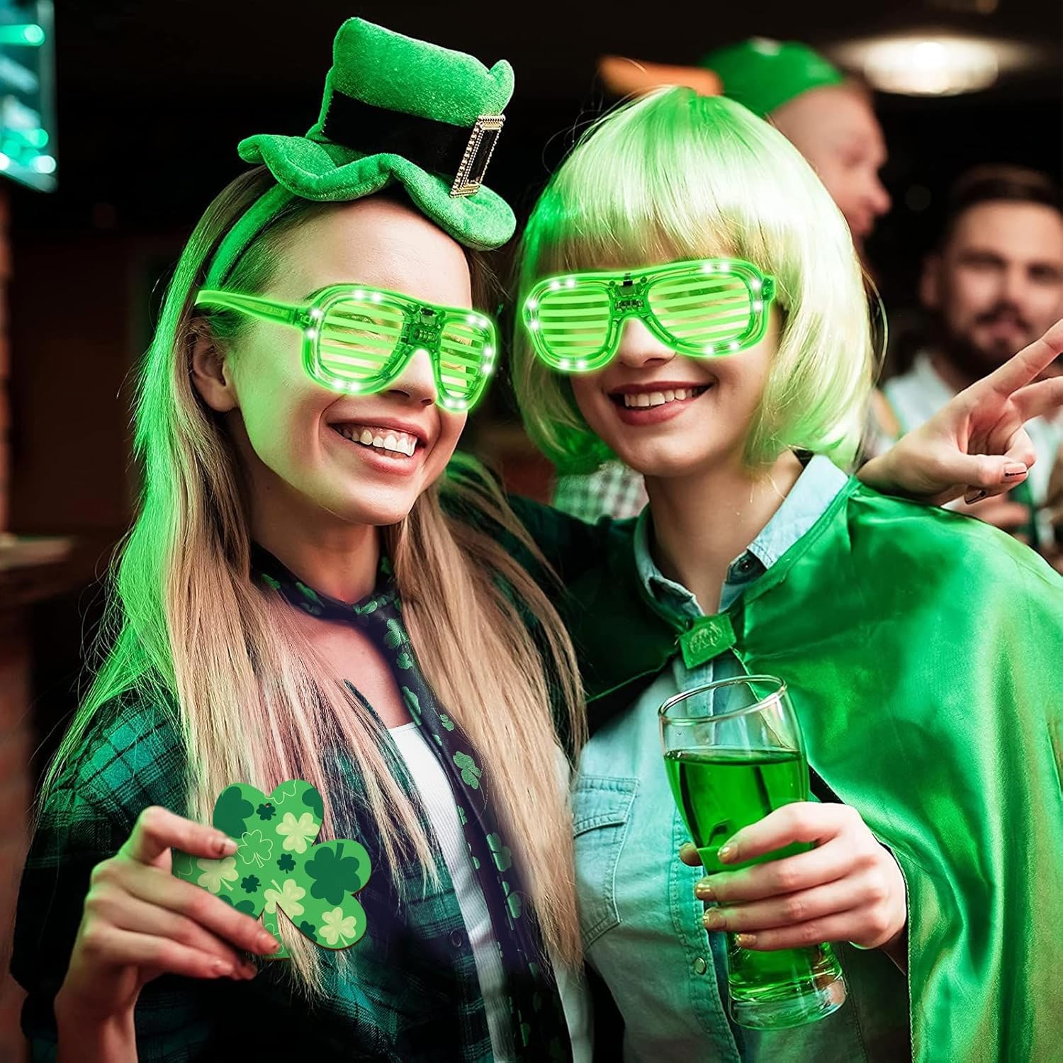 Two people celebrating St. Patrick's Day with green LED glasses and costumes.