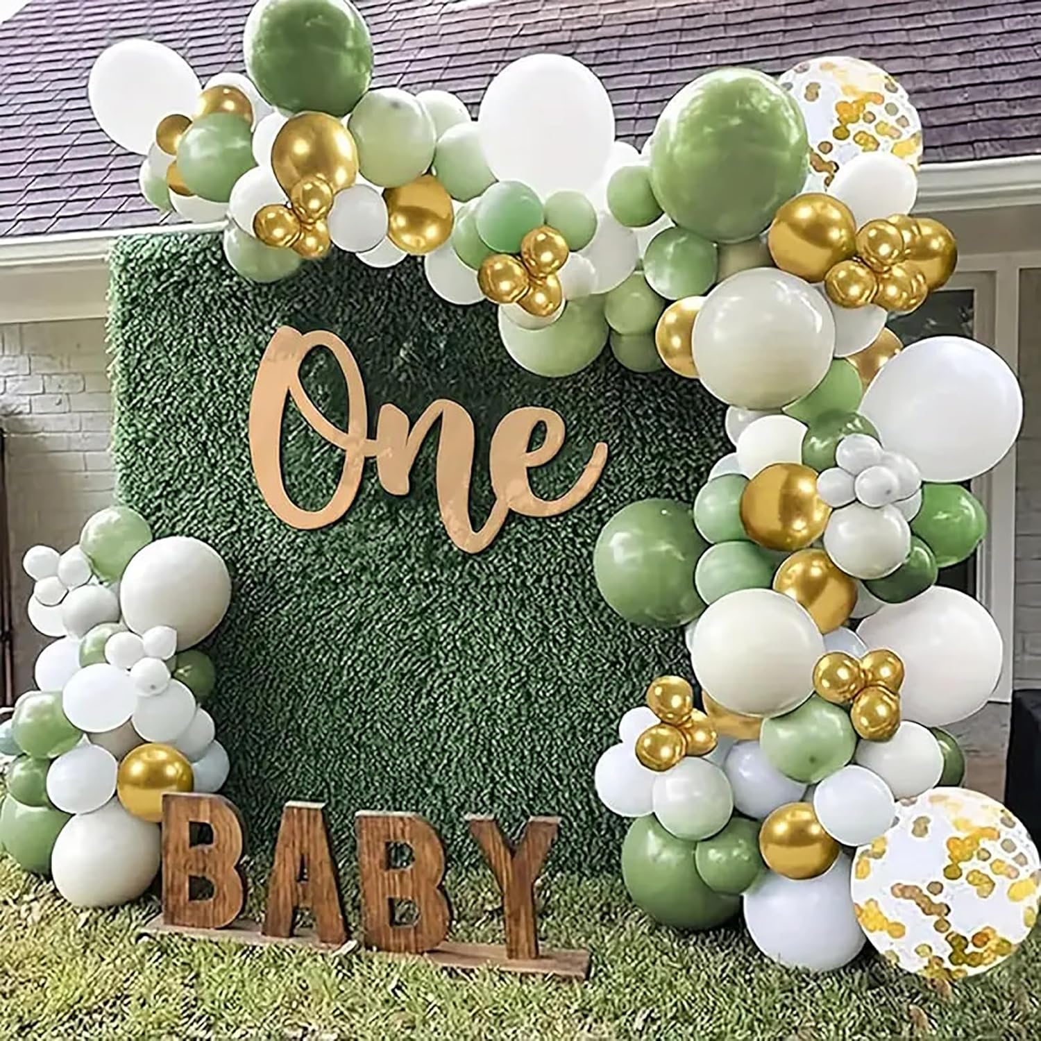 Balloon arch with 'One Baby' sign in front of a house