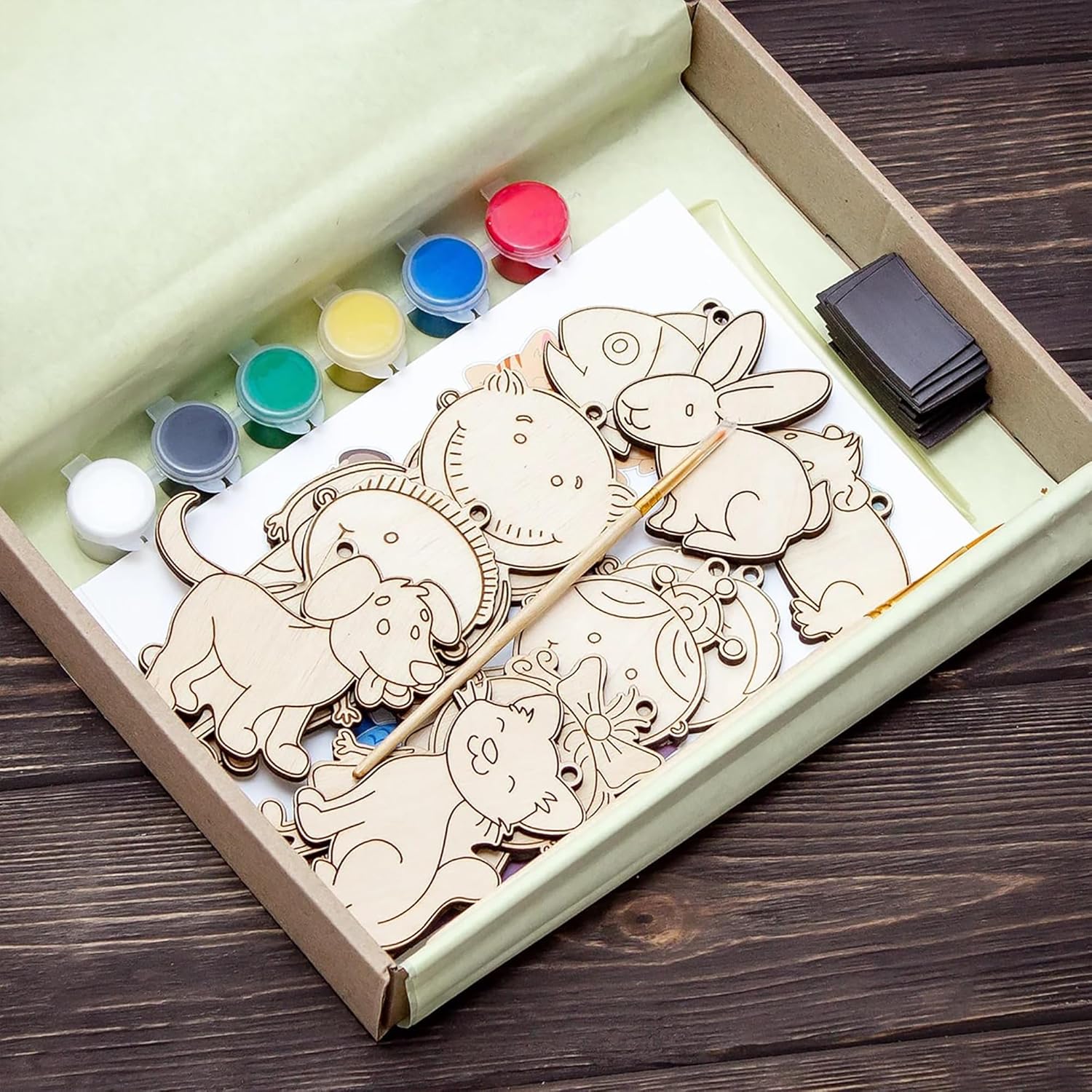 Wooden puzzle with paint and brush set in a box on a wooden surface
