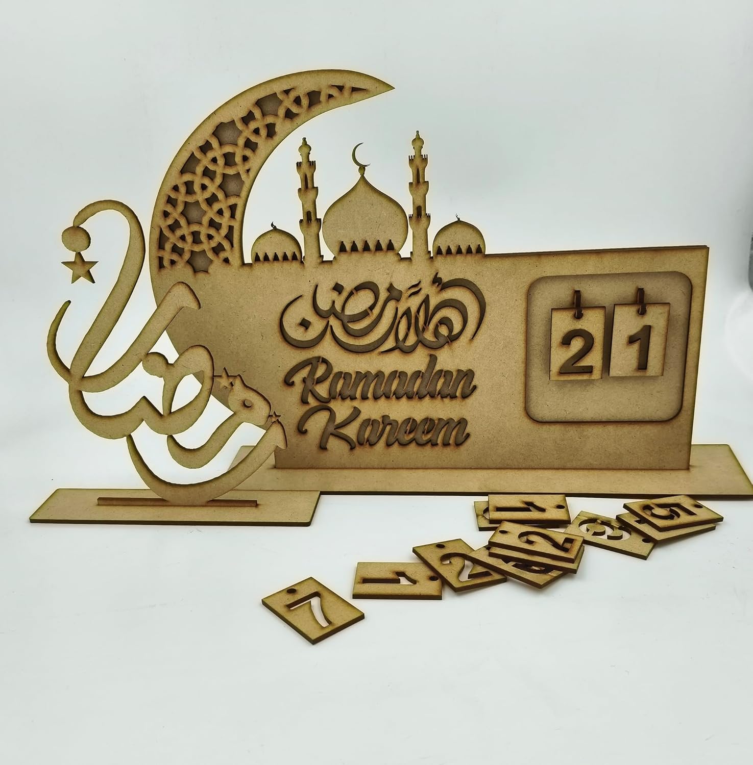 Decorative wooden sign with 'Ramadan Kareem' and a calendar on a white background