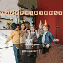 Children celebrating a birthday with a cake and 'Happy Birthday' text overlay.