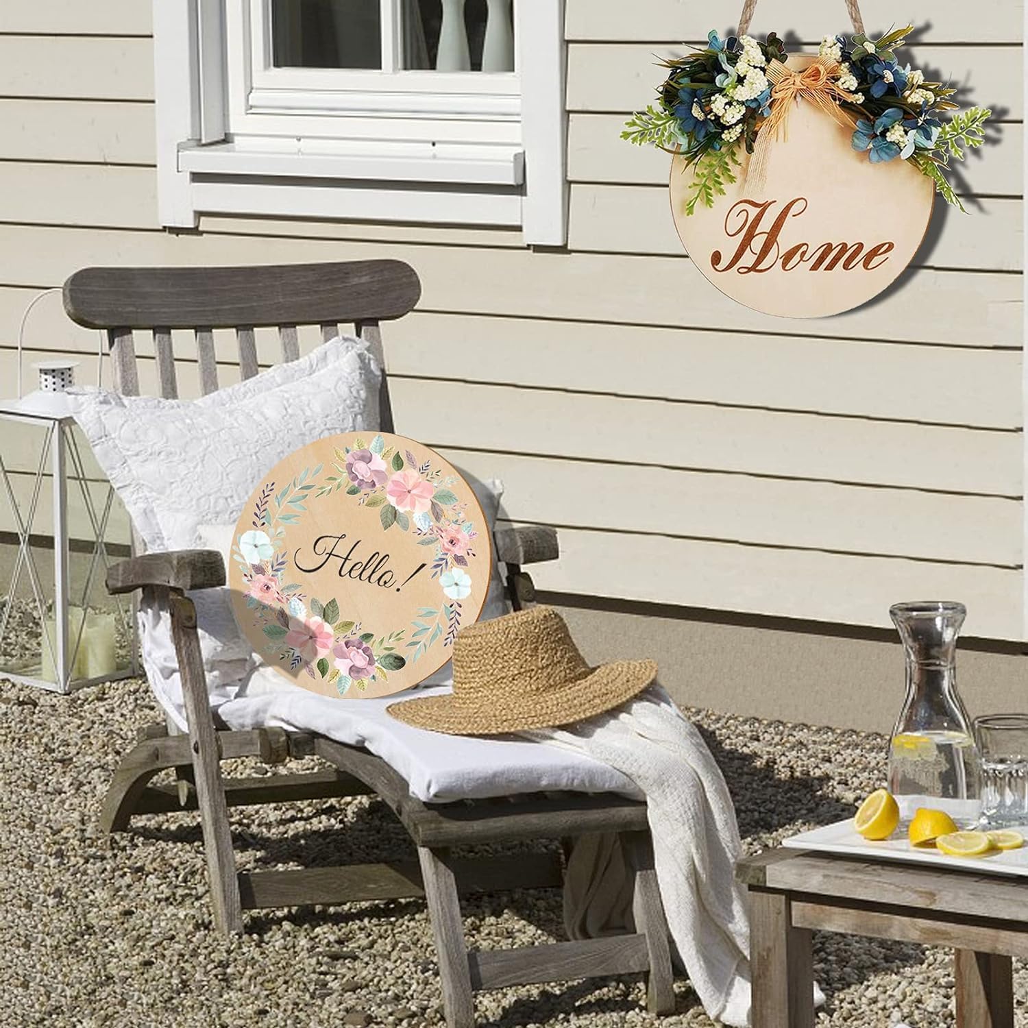 Chair with decorative signs reading 'Hello' and 'Home', straw hat, and lemon slices on a patio.