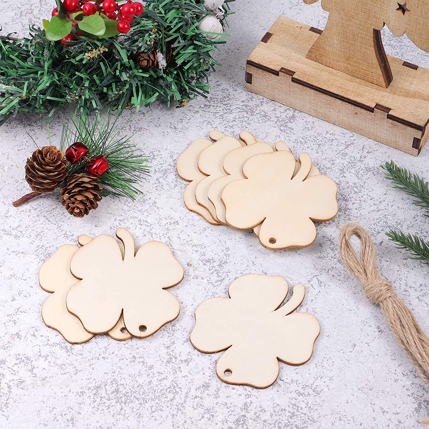 Wooden Christmas ornaments on a textured surface with decorative elements.