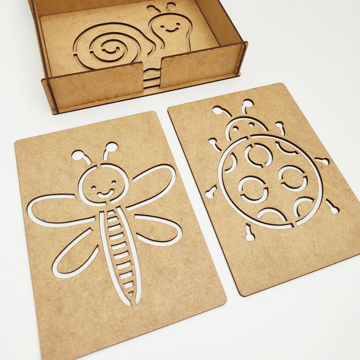 Two cardboard cutouts of a dragonfly and a snail on a white background